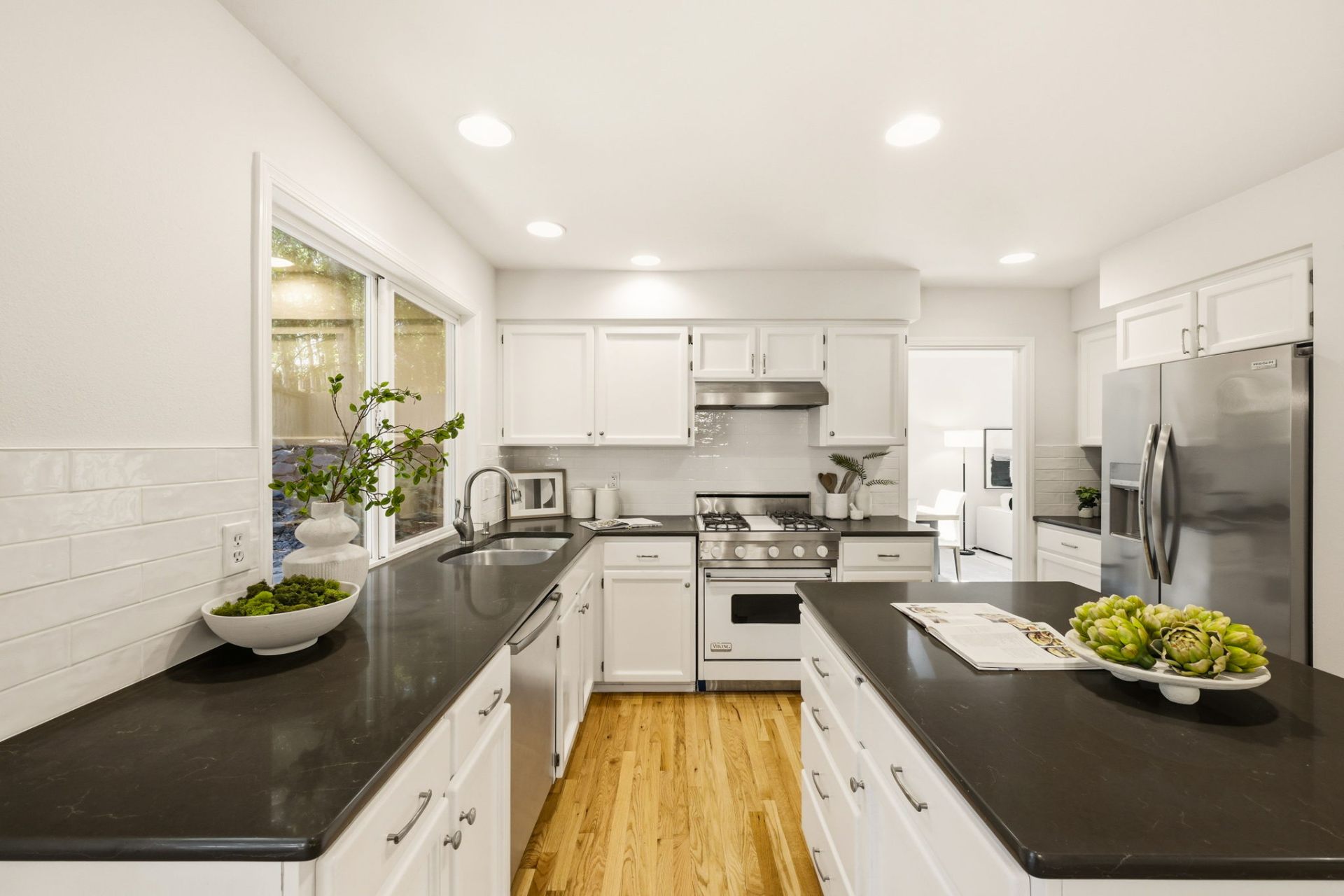 Refreshed kitchen with white cabinetry, stainless appliances, and a center island